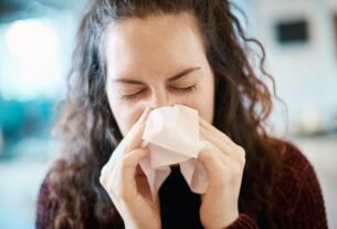 a woman suffering a nosebleed and headache