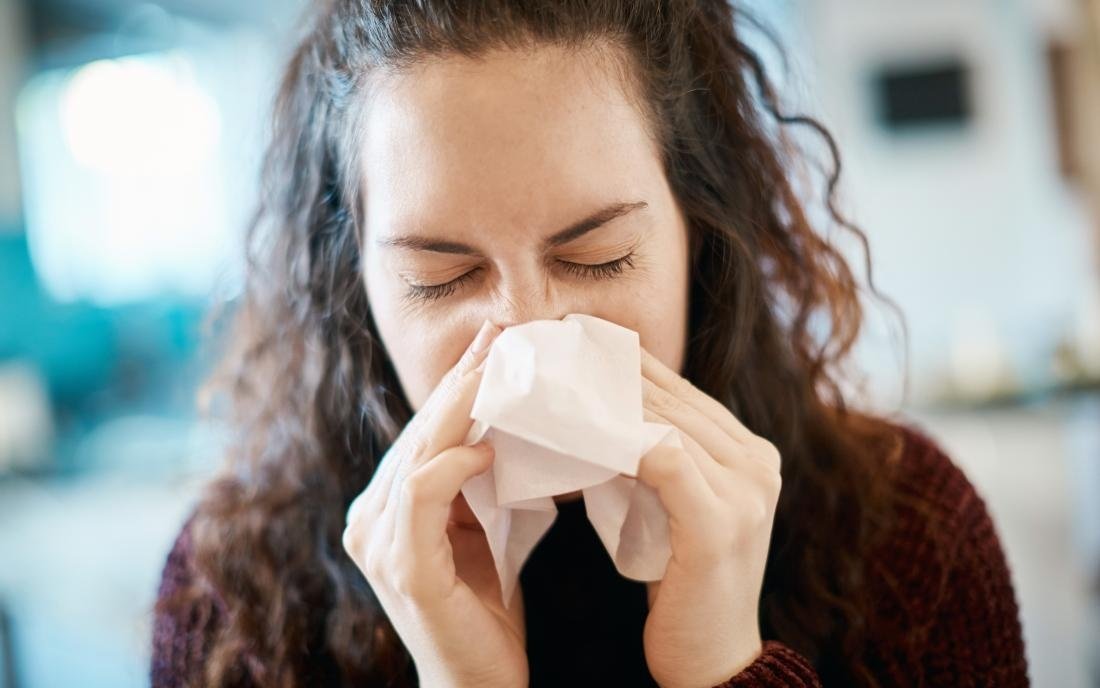 a woman suffering a nosebleed and headache